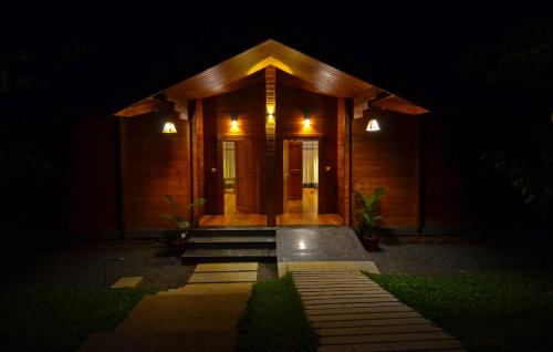 a house at night with the front door lit up at LakeRose Wayanad Resort in Ambalavayal