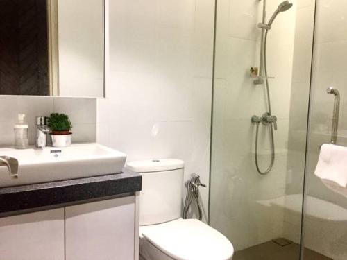 a bathroom with a toilet and a sink and a shower at Charming Bedroom - next to train station at Est Bangsar in Kuala Lumpur