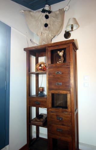 a wooden cabinet with a tv in a room at Polyxenia Hotel in Nafplio