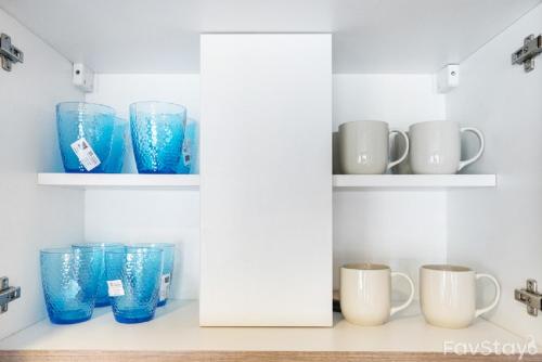 a row of blue cups and mugs on shelves at Rain Cha-am Huahin By Sake in Cha Am