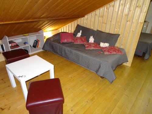 deux animaux en peluche assis sur un lit dans une pièce dans l'établissement La SALAMANDRE, à Gérardmer