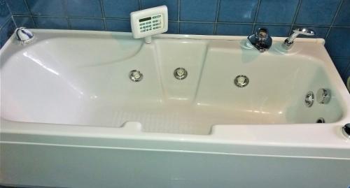 a white bath tub with a faucet in a bathroom at Villa Maria Sole in Revello