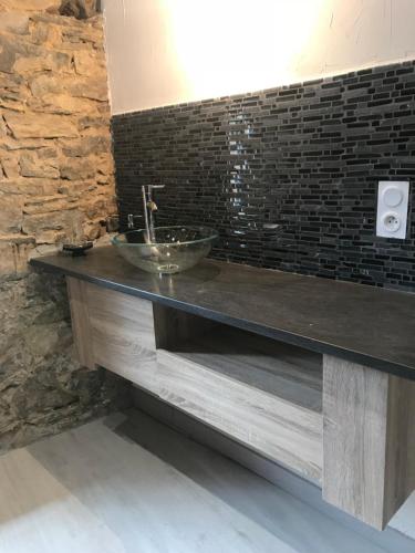 a bathroom with a counter with a sink at Domaine d'Alcapiès in Saint-Jean-dʼAlcapiès