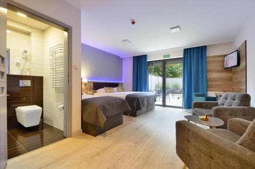 a hotel room with a bed and a couch at Luna in Zielona Góra