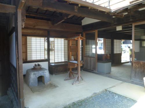 a room with a stove in the middle of a building at Wakihonjin in Kikugawa