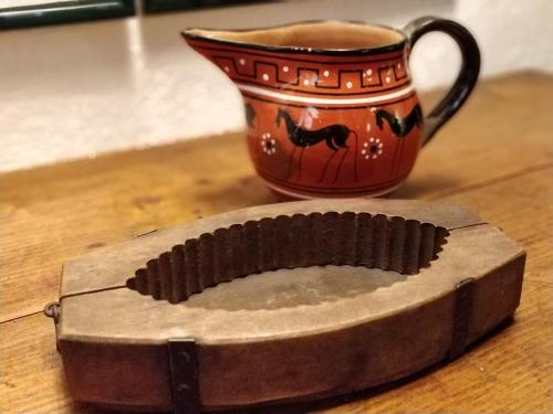 a cup of coffee sitting next to a coffee maker at Casa Messi in Pitigliano