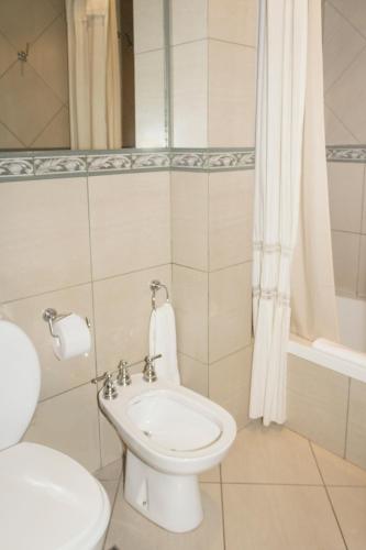a bathroom with a toilet and a sink and a shower at O2 Hotel Buenos Aires in Buenos Aires