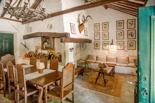a dining room with a table and a couch at Quinta do Tojal in Ferreira do Zêzere