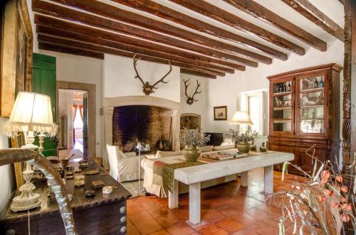 a living room with a table and a couch at Quinta do Tojal in Ferreira do Zêzere