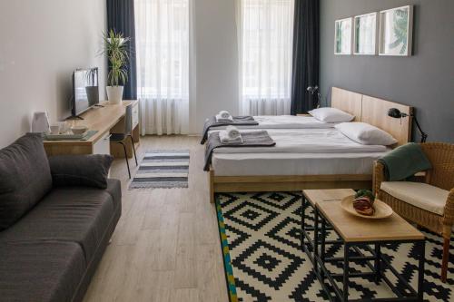a living room with a bed and a couch at Arhiv Boutique House in Novi Sad