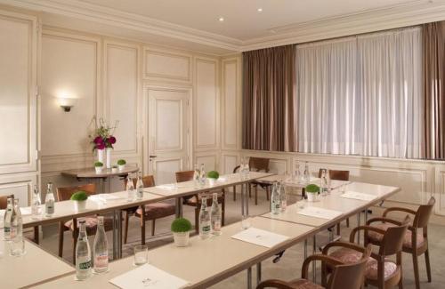 a large room with tables and chairs and flowers at Hôtel Bedford in Paris
