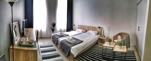a bedroom with a large bed and a large window at Arhiv Boutique House in Novi Sad