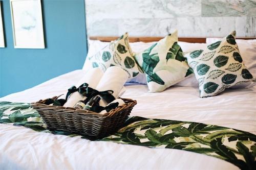 a basket of shoes sitting on top of a bed at Rain Cha-am Huahin By Sake in Cha Am
