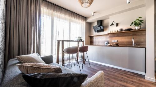 a living room with a couch and a table at Tamara Suites & Apartments in Jūrmala