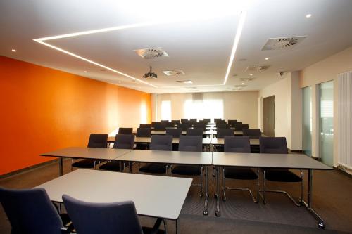 a conference room with tables and chairs in it at SportHotel Kaiserau in Kamen