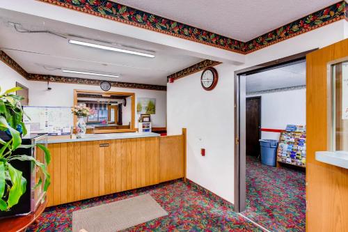 an empty office with a counter in a room at Motel 9 in Fort Collins