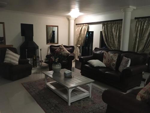 a living room with a couch and a coffee table at Meraki Country Manor in Lanseria
