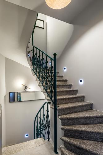 a staircase with blue railings in a house at Apartamenty Centrum Częstochowa Stara Kamienica in Częstochowa