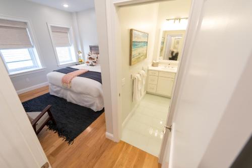 a bedroom with a bed and a bathroom with a mirror at The Newport Lofts - 364 Thames Street in Newport