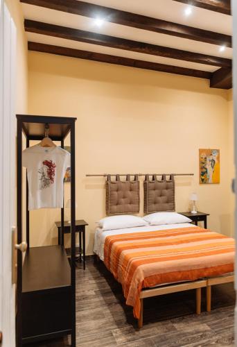 a bedroom with a large bed with a orange blanket at Il Tempo Ritrovato - Locazione ad uso turistico in Palermo