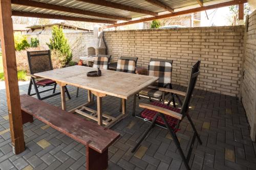 a wooden table and chairs on a patio at Vila Veronika in Lednice