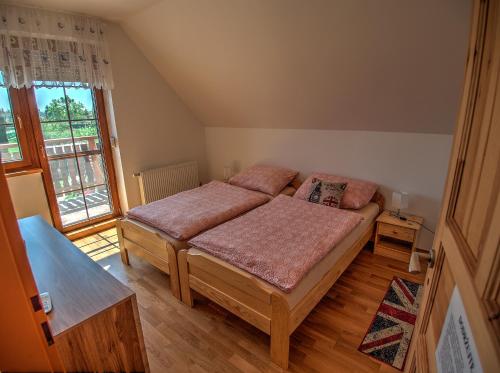 a bedroom with a bed and a large window at Vila Veronika in Lednice
