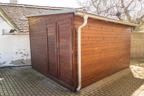 a wooden shed with a hose coming out of it at Vila Veronika in Lednice