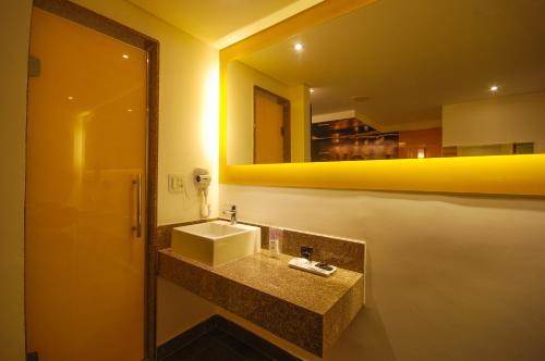 a bathroom with a sink and a mirror at Motel Classe A (Adult Only) in Sao Paulo