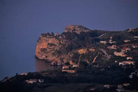 a view of a mountain with a body of water at B&B Tre Giummare in Scopello