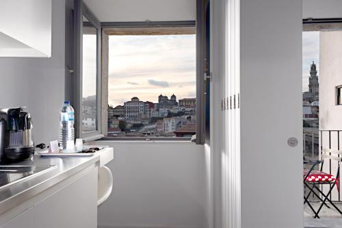 a kitchen with a view of a city from a window at Oldcity Design Apartments in Porto