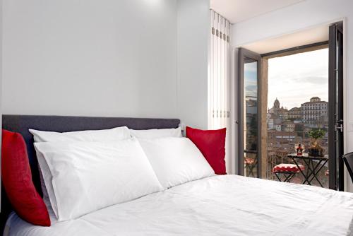 a hotel room with a bed and a window at Oldcity Design Apartments in Porto
