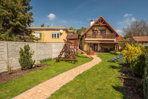 a yard with a fence and a house at Vila Veronika in Lednice