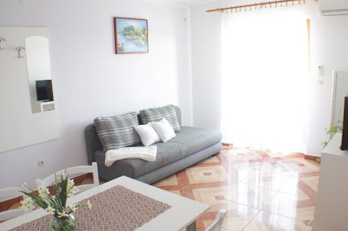 a living room with a couch and a table at Apartmani Adrijan Krk in Krk