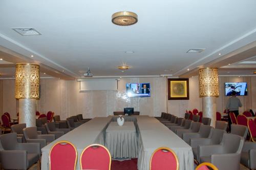 a conference room with a long table and chairs at Sania Hotel in Sidi Bennour