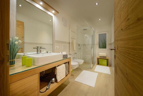 a bathroom with a sink and a toilet at Apartment Cësa Zinch in Ortisei