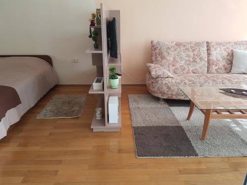 a living room with a couch and a table at Mommy's House in Varna City