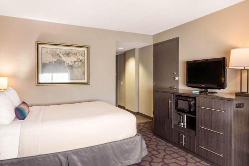 a hotel room with a bed and a flat screen tv at Comfort Inn Largo-Washington DC East in Upper Marlboro