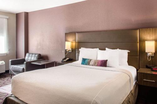 a hotel room with a large bed and a chair at Comfort Inn Largo-Washington DC East in Upper Marlboro