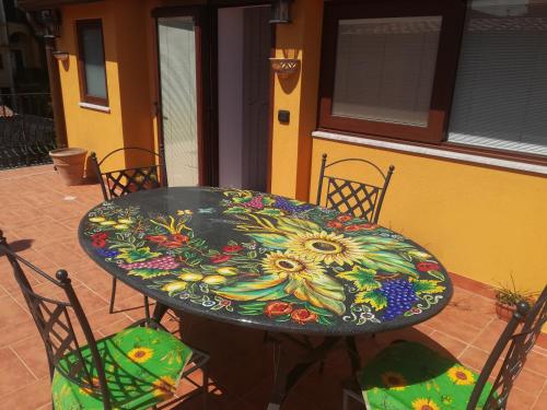 a table with a flower painted on it at Attico Sole Luna in Taormina