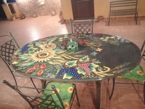 a table with a flower painted on top of it at Attico Sole Luna in Taormina