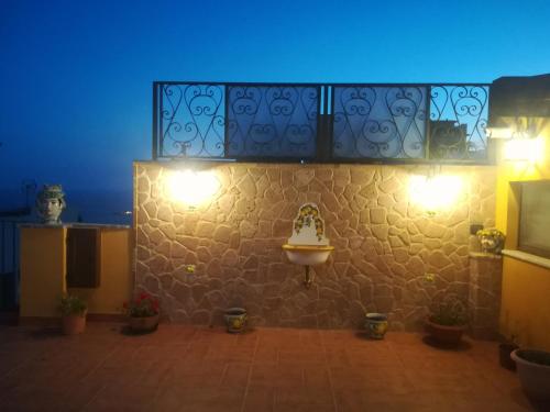 a room with a wall with lights on it at Attico Sole Luna in Taormina