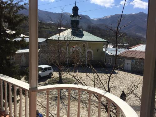 a view from a balcony of a church with a clock tower at Lahic Hostel in Lahıc