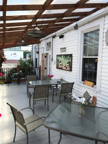 a patio with tables and chairs on a house at Rose Manor Bed & Breakfast in New Orleans