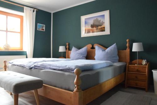 a bedroom with a large bed with blue walls at Ferienhaus Eitel in Spalt