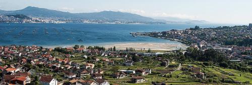 an aerial view of a town next to the ocean at Hotel Bienestar Moaña in Moaña