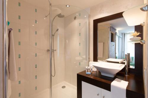 a bathroom with a sink and a shower at Aby in Cannes