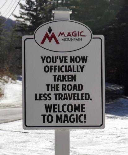a sign that says youre now officially taken the road less travelled welcome to magic at Snowdon Chalet Motel in Londonderry