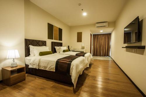 Postel nebo postele na pokoji v ubytování Aman Hills Hotel
