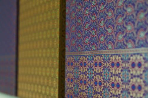 a close up of a curtain with a pattern on it at Aman Hills Hotel in Kampong Timbunan