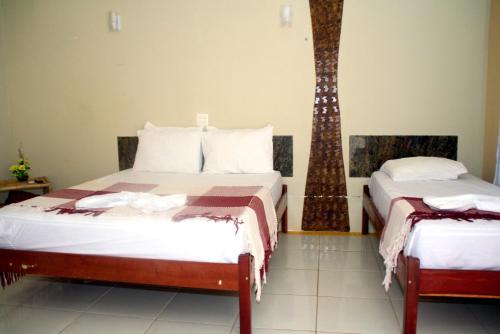 
Cama ou camas em um quarto em Chalemar Hotel Pousada
